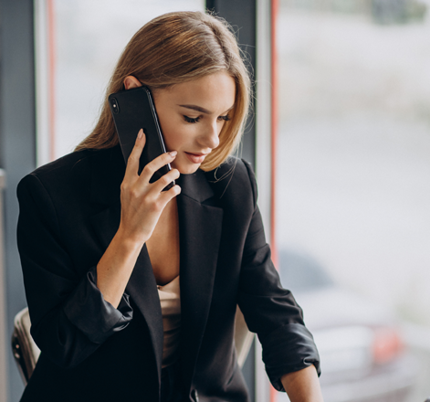 A woman is talking on a cell phone with a client about IT solutions Services | IT Solution | Laptop Repairing Services | IT Procurement | Door Step Services